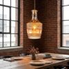 DECANTER amber glass pendant light over dining table in industrial loft
