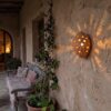 Moroccan Terracotta Perforated Egg Wall Sconce - Installed Room Setting Warm Ambient Interior Illumination