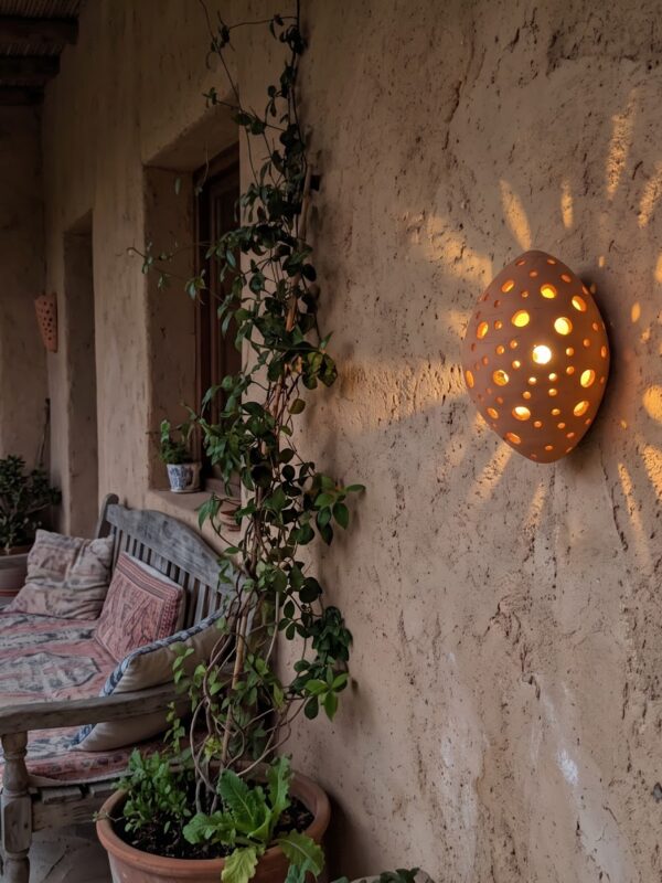 Moroccan Terracotta Perforated Egg Wall Sconce - Installed Room Setting Warm Ambient Interior Illumination