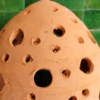 Moroccan Terracotta Perforated Egg Wall Sconce - Illuminated Night Shadow Pattern and Pierced Light Projection