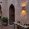 Moroccan Terracotta Carved Globe Wall Sconce - Installed Room Setting Warm Ambient Interior Illumination