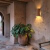 Moroccan Pink Terracotta Concave Wall Sconce - Installed Room Setting Warm Ambient Interior Illumination